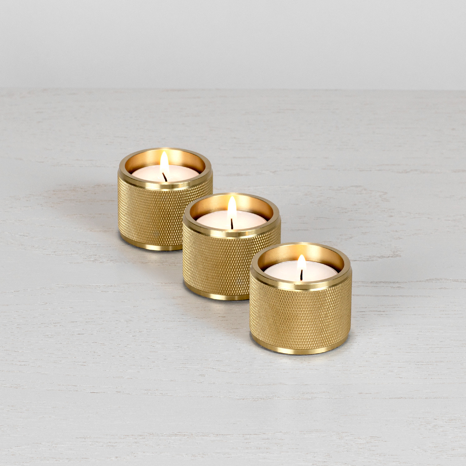 Three tealight candle holders made from solid brass